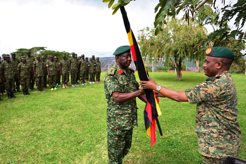 Maj Gen Joseph Musanyufu hands Uganda flag to UPDF team head