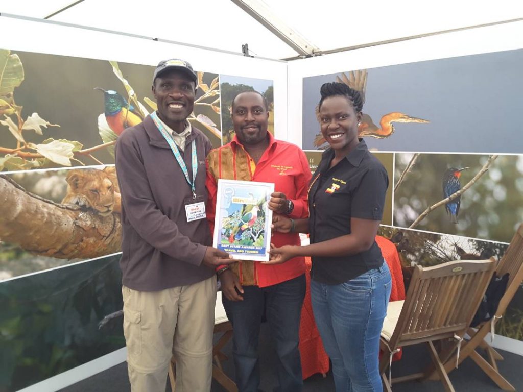 Uganda Tourism Board's Marketing Edwin Muzahura (C), Dorcus (R) and Livingstone (L) an ardent birder of African Safaris Ltd display the certificate