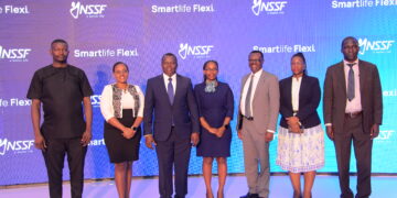 L-R(Thadeus Musoke, the KACITA Chairman, Vanessa, the 1st Smartlife Flexi Customer, Dr David Ogong, NSSF Board Chairman, Hilda Nakagga from the Ministry of Gender, Patrick Ayota, the Managing Director NSSF, Ms Agnes Tibayeita, the Corporation Secretary NSSF and Apollo Onzoma, the Assistant Commissioner of Industrial Relations at the Ministry of Gender) pose for a photo during the launch of Smartlife Flexi in Kampala today.