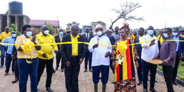 President Museveni cuts the tape as he commissions Bugisu Industrial skilling hub in Lukhonge, Mbale district on Wednesday as Ministers Gidudu (3rd L), State House Comptroller Jane Barekye (L), Hon Nambozo