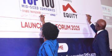 Claver Serumaga, the new Executive Director at Equity Bank Uganda, and Susan Nsibirwa, Managing Director of Nation Media Group Uganda, launching the Top 100 Midsized Companies Survey