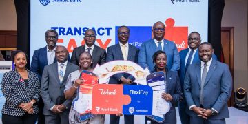 Julius Kakeeto, Managing Director of Pearl Bank (formerly PostBank Uganda) (back centre), Mumba Kenneth Kalifungwa, Managing Director of Stanbic Bank Uganda (back 2nd right), Priscilla Akora, Head of Marketing and Communications at Pearl Bank (3rd left), and Diana Kahunde, Head of Brand and Marketing at Stanbic Bank (2nd right), join other officials from both institutions during the launch of the Wendi by Pearl Bank and FlexiPay partnership at the Sheraton Hotel, Kampala, on Thursday, 23rd October 2025.