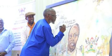 Keynote Speaker Prof. Abasi Kiyimba, famously known as AK in the corridors of the Literature Department at Makerere University, signs a portrait of the late Prof. Ngũgĩ wa Thiong’o.